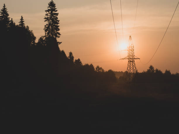 istock orange dawn with high voltage tower wires and nature 1412216566