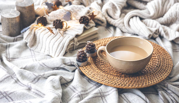 istock Cozy autumn composition with a big cup of coffee in bed. 1412217193