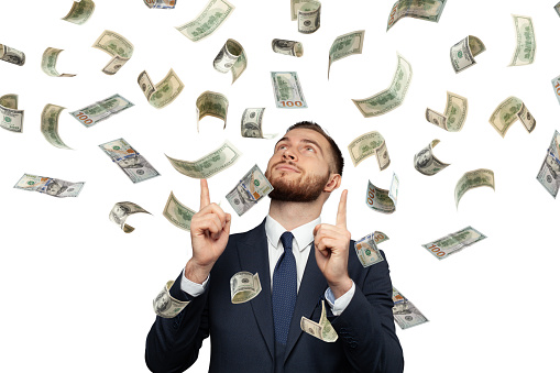 Smart businessman with falling 100 dollar cash money isolated on white background