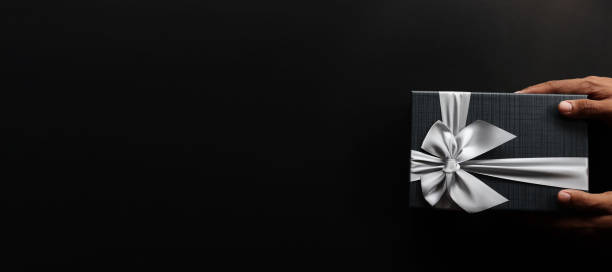 istock Black gift box  with luxury bow on dark background with copy space, Christmas gift 1412219014