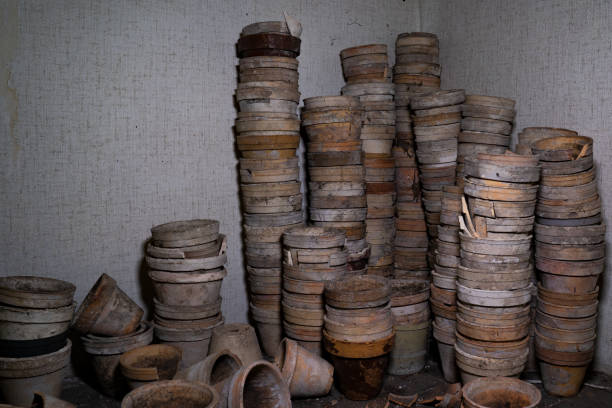 Disused dirty flowerpots on a shabby shelf