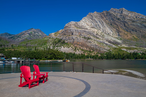 Two of over 200 red Adirondack chairs placed in breathtaking locations in Canada for discovering the wonders of Canadian Parks.