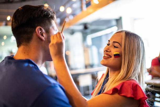 istock Friends painting a face at a bar 1412220267