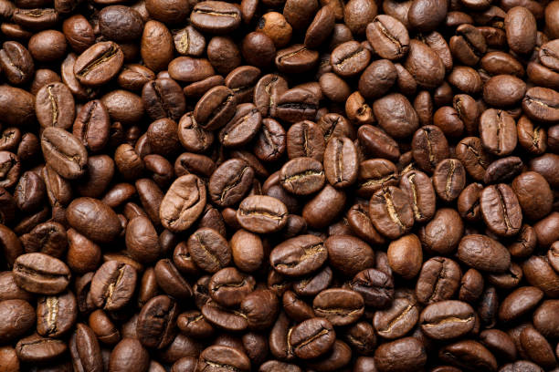 istock Pile of roasted coffee beans as background, top view 1412220277