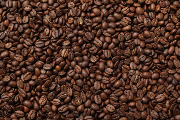 istock Pile of roasted coffee beans as background, top view 1412220972
