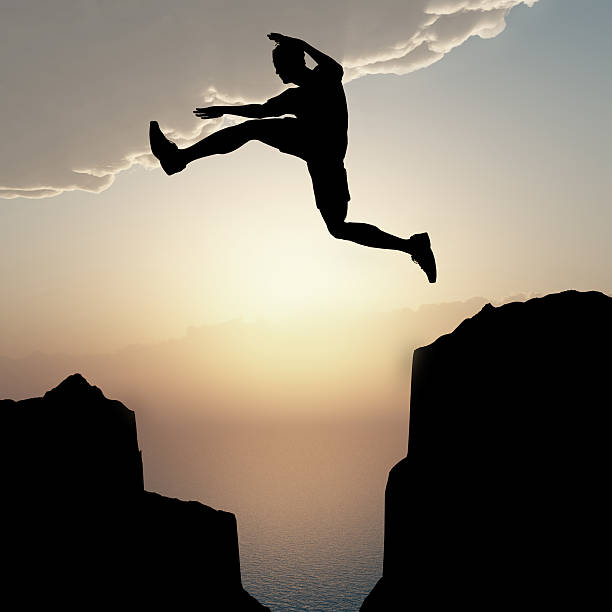 istock Silhouette of the jumping man from a rock 141222104