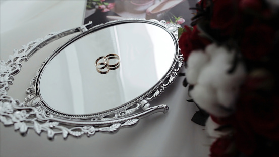 Beautiful wedding rings on a vintage mirror. wedding rings on the mirror surface.