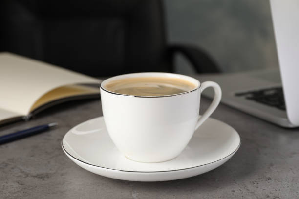 istock Cup of americano on grey table in office. Coffee Break 1412221160
