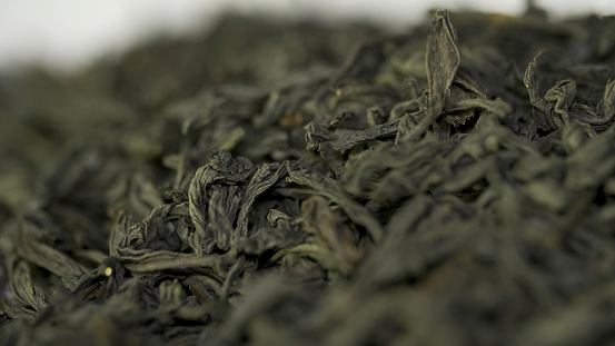Dry tea, dried leaves. Black tea leaves background. dry leaf green tea on a white background. Pile of dry tea, close up.