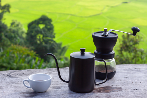 Drip coffee set on wooden table in morning with rice field background, Set for make coffee drip