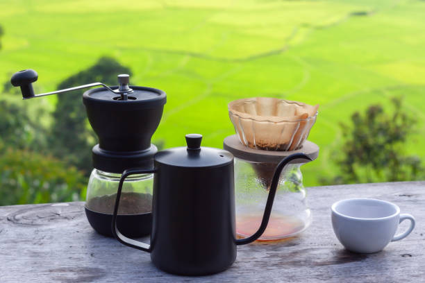 istock Drip coffee set on wooden table in morning with rice field background 1412221402