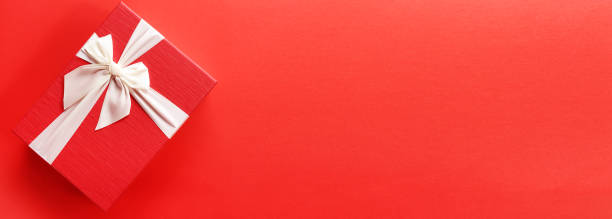 istock Big day gift, Red gift box  with luxury bow on red background with copy space. 1412222729