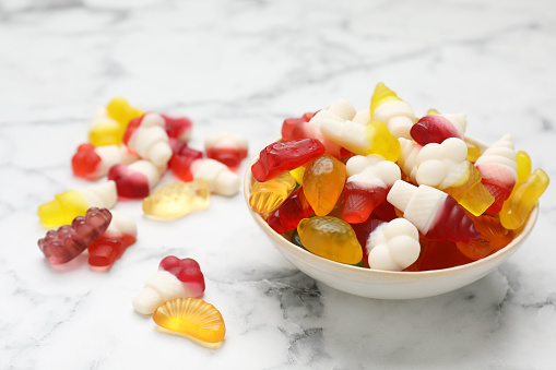 Multi colored gummy bears candy on white