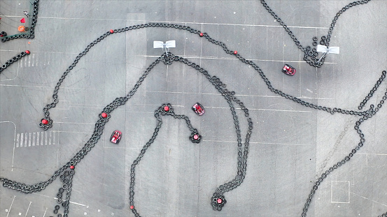 Aerial view of the karting track with moving small red karts, race and motorsport concept. Media. Top view of curves on karting race track.