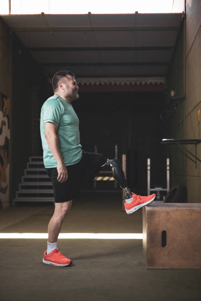 istock An adult man with a prosthetic leg stretching it. Overcoming and perseverance. 1412225112