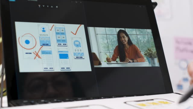 close up hand of woman ux ui developer use interactive board to explain coworker on online conference video call