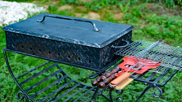 istock Brazier and accessories on metal rack in green yard 1412226736
