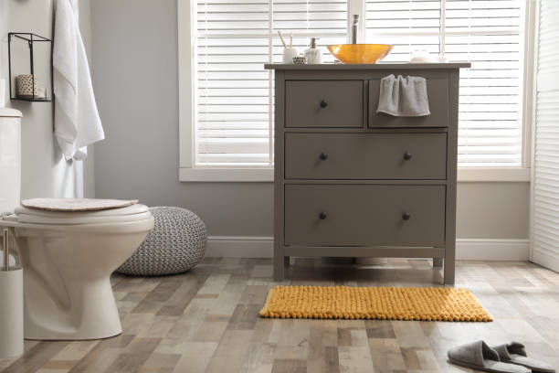 Custom beige toned master bathroom with double pedestal sinks and hot tub style tub in a beautiful suburban home.