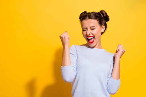 Photo of ecstatic lady shout loud yeah fist up raise win lottery isolated bright shine color background.