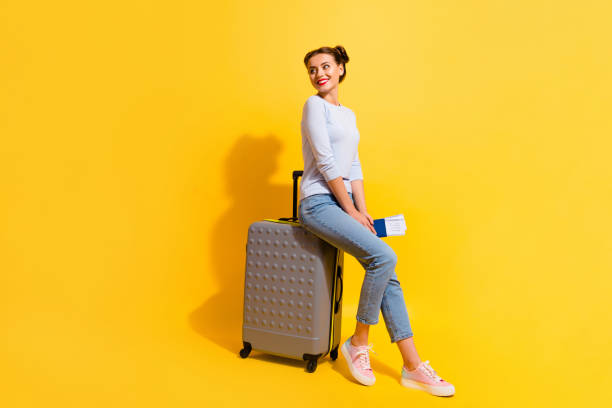 istock Photo of positive lady looking copyspace sit baggage with visa wait for verification isolated shine color background 1412229297