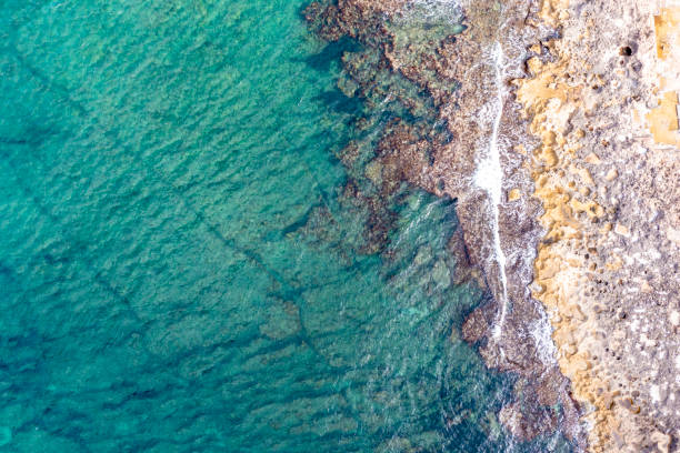 istock Aerial view of waves splashing on beach 1412229537