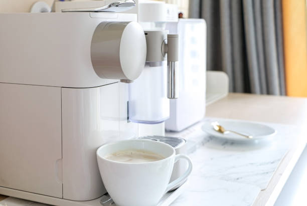 istock A white mug of espresso coffee brewing under coffee maker machine. A modern home/office coffee machine 1412229613