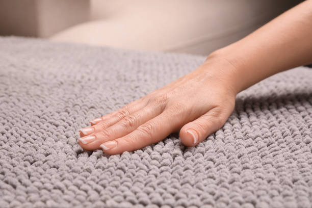 istock Woman touching soft grey fabric indoors, closeup 1412230502