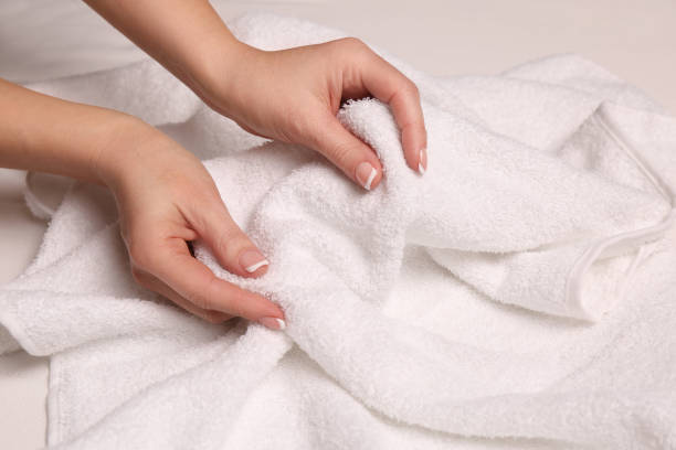 Woman touching soft white towel, closeup view Woman touching soft white towel, closeup view terry towel stock pictures, royalty-free photos & images