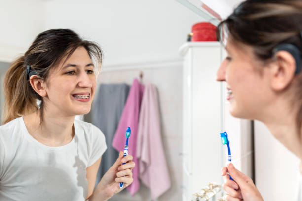 istock Young woman is brushing her teeth in a bathroom 1412230694