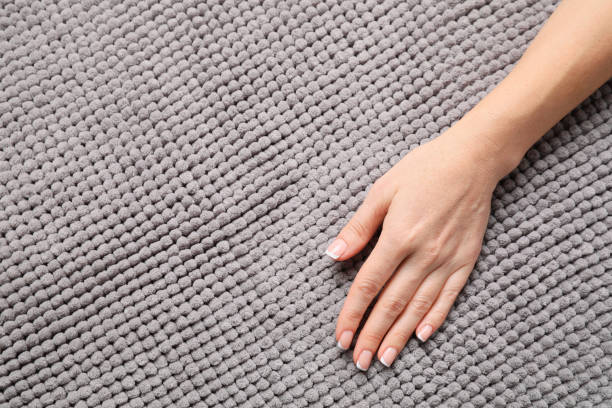 istock Woman touching soft grey fabric, top view. Space for text 1412230888