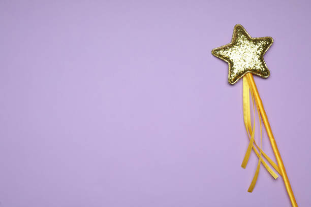 istock Beautiful golden magic wand on lilac background, top view. Space for text 1412231928