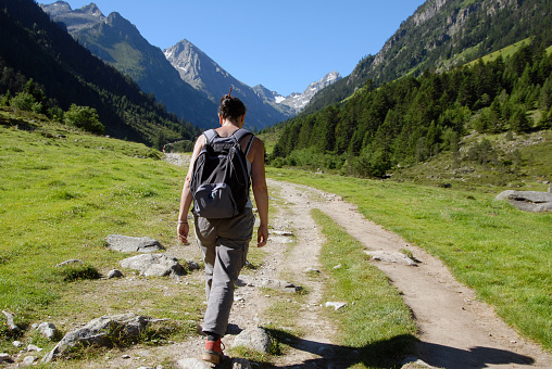 hiker in action in Ferret valley with Mont Blanc massif on background