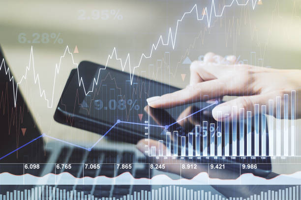 istock Multi exposure of abstract financial graph and hand working with a digital tablet on background, financial and trading concept 1412232917