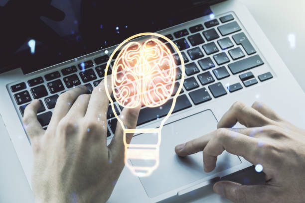 istock Creative idea concept with light bulb and human brain illustration and with hands typing on laptop on background. Neural networks and machine learning concept. Multiexposure 1412233539