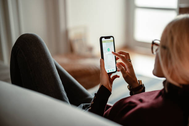 istock Unrecognizable Woman Using A Mobile Phone App For Online Banking 1412233595
