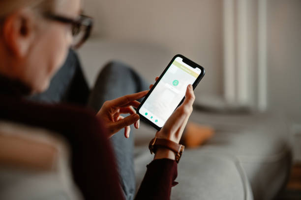 istock Unrecognizable Woman Using A Mobile Phone App For Online Banking 1412233599