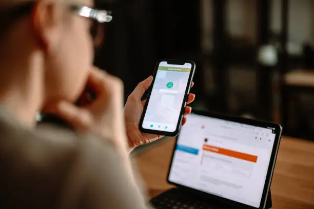 Photo of From Above Photo Of An Anonymous Woman Using A Mobile Phone And Tablet For Online Banking