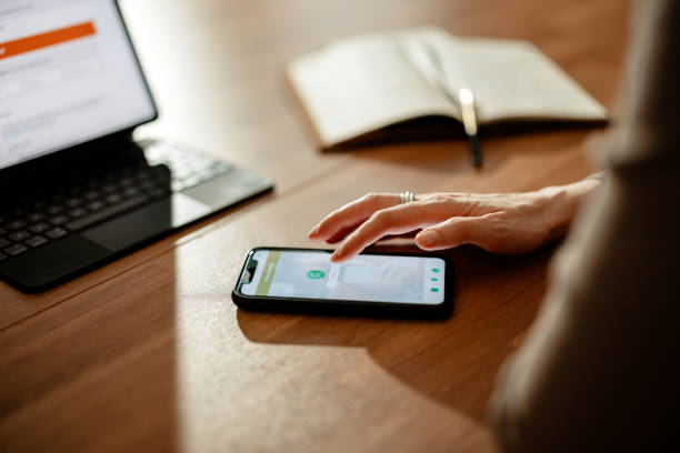 istock Unrecognizable Woman Using A Mobile Phone And Tablet For Online Banking 1412233617