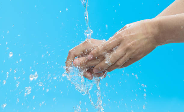 istock Woman washing hands under flowing water 1412242233