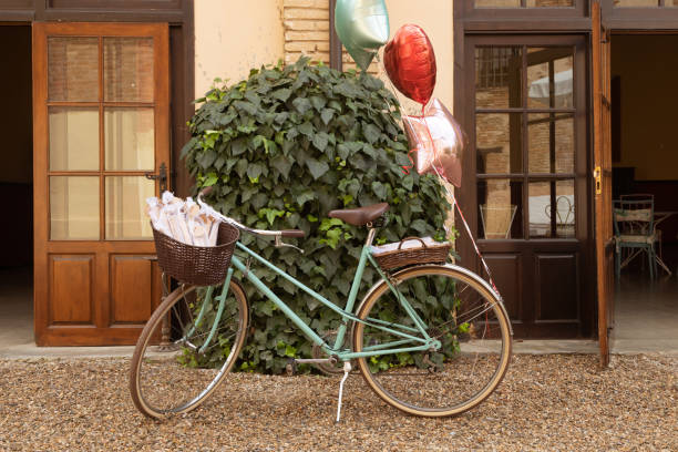 istock Decorative bicycle painted in green, with several tied balloons, Spain 1412244076