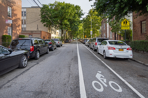 View up 40th Avenue in Long Island City in Queens. The street is one way and there are a marking of a bicycle lane