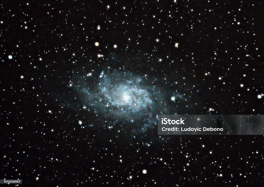 The Triangulum Galaxy The Triangulum Galaxy is a spiral galaxy 2.73 million light-years from Earth in the constellation Triangulum. It is catalogued as Messier 33 or NGC 598. The Triangulum Galaxy is the third-largest member of the Local Group of galaxies, behind the Andromeda Galaxy and the Milky Way. It is one of the most distant permanent objects that can be viewed with the naked eye. Astronomical photography with apochromatic refractor 80mm Galaxy Stock Photo