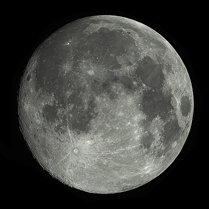 The full Moon is seen isolated on a white background. High contrast, high resolution image taken with a full frame dslr camera.