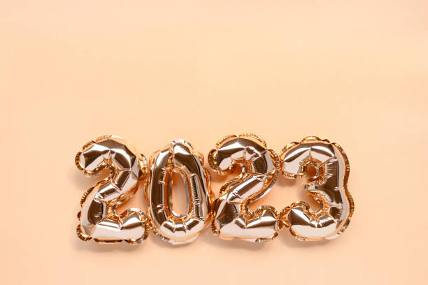 istock 2023 golden balloons on a shiny background with copy space. 1412245938