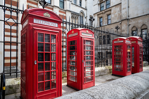A row of 4 iconic British telephone boxes