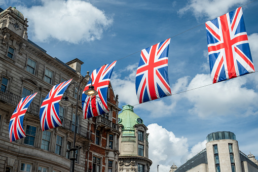 Union Jacks flying over a London Street marking the Queen's Platinum Jubilee, marking the 70th anniversary of the Queen's accession to the throne.
