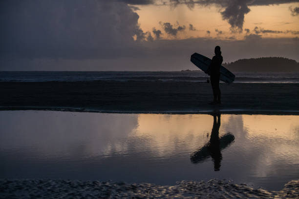 istock Surfer on beach checking conditions in Tofino BC 1412248509