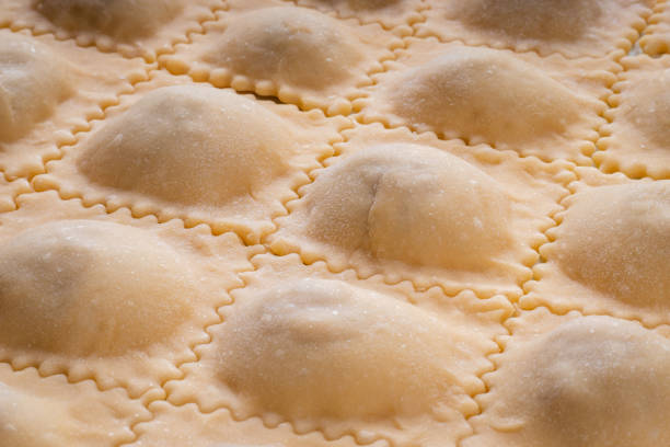Making homemade ravioli, italian cuisine, uncooked pasta