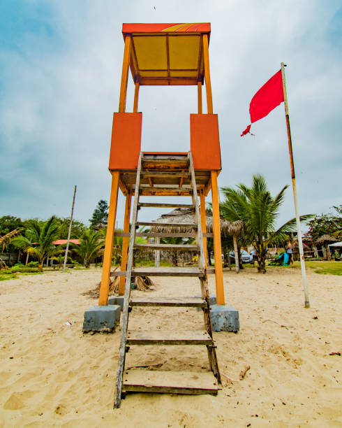 istock LIFEGUARD CHAIR WITH RED FLAG WITH SUNNY DAY 1412249632