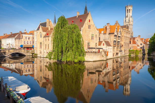 istock Rozenhoedkaai canal reflection at sunrise and clear sky, Bruges 1412250772